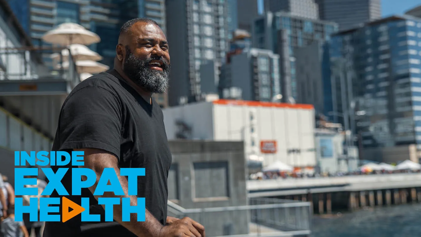 Fijian expat Pate looking out over the water in Seattle, smiling