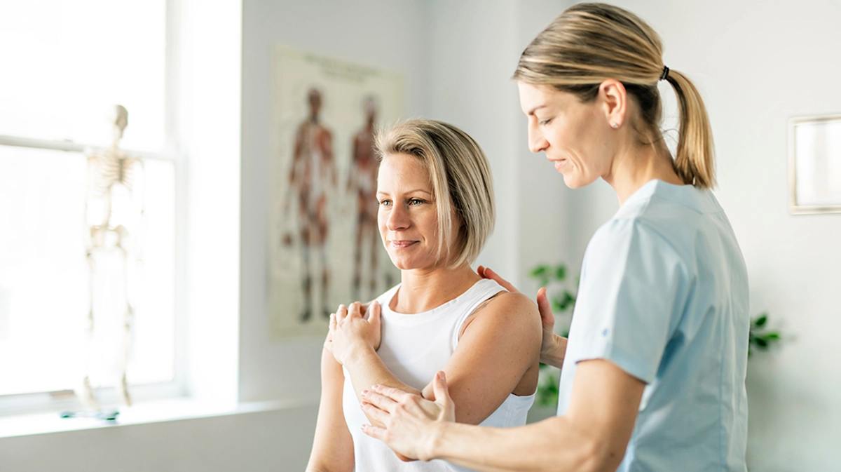 A woman and her physio try some arm exercises